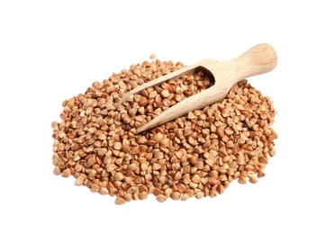 Scoop and pile of uncooked buckwheat on white background