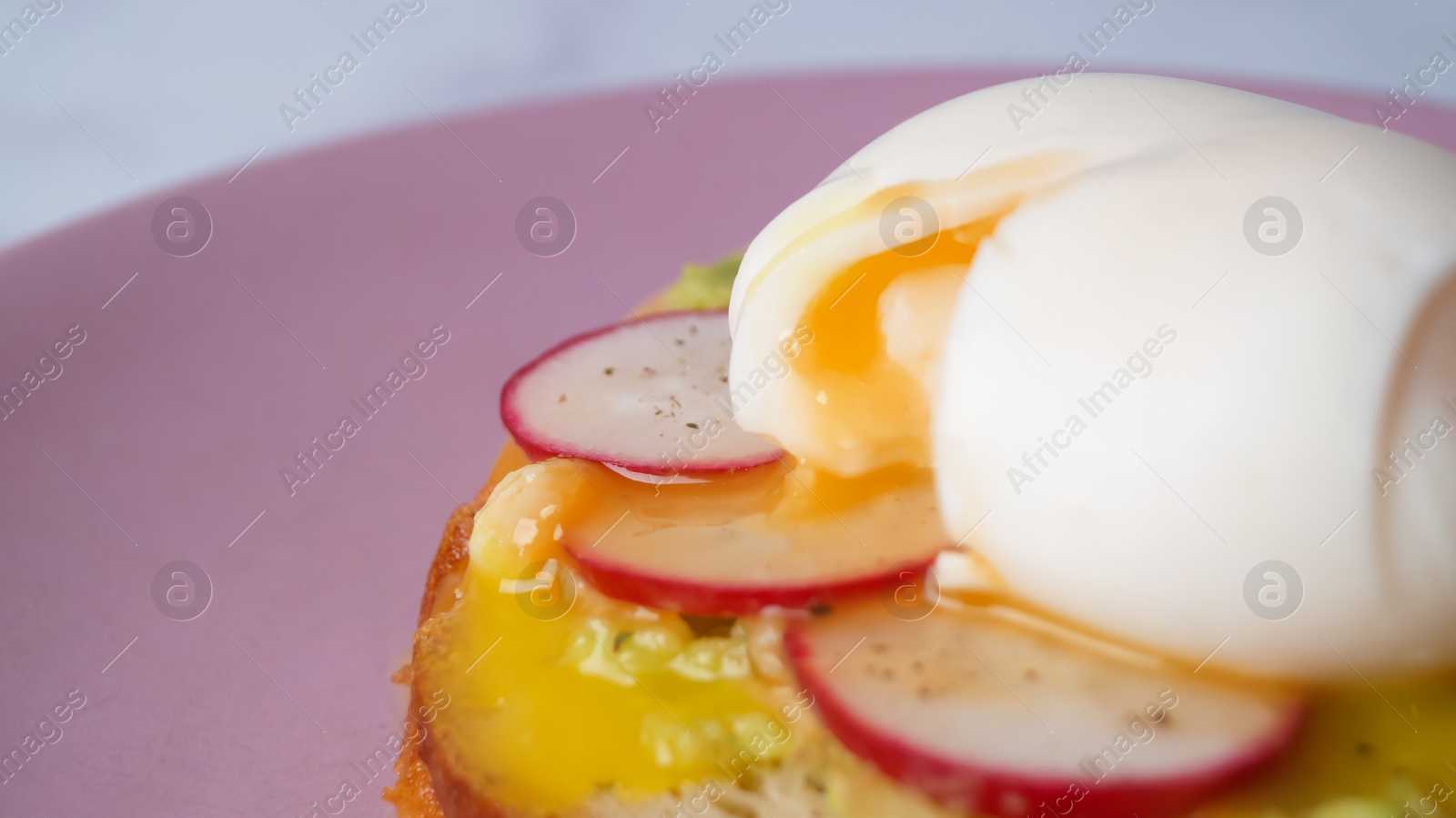 Photo of Tasty sandwich with boiled egg and radish on pink plate, closeup