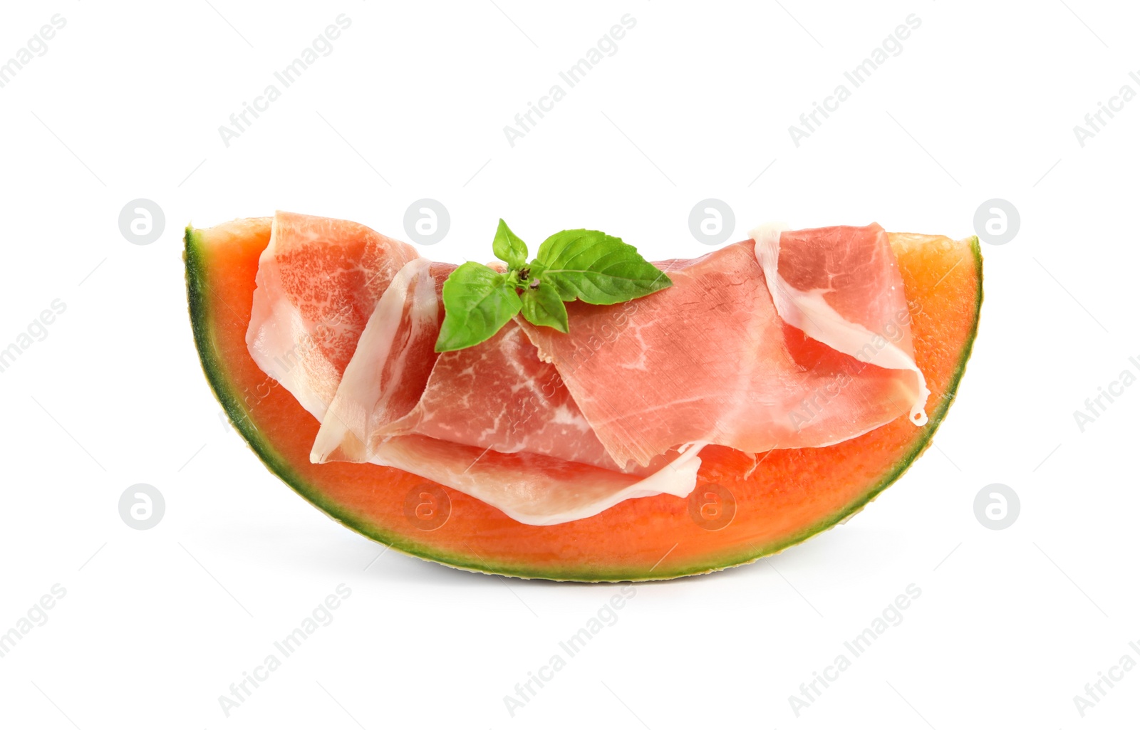 Photo of Slice of fresh melon with prosciutto and basil on white background