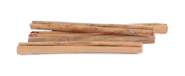 Photo of Aromatic brown cinnamon sticks on white background