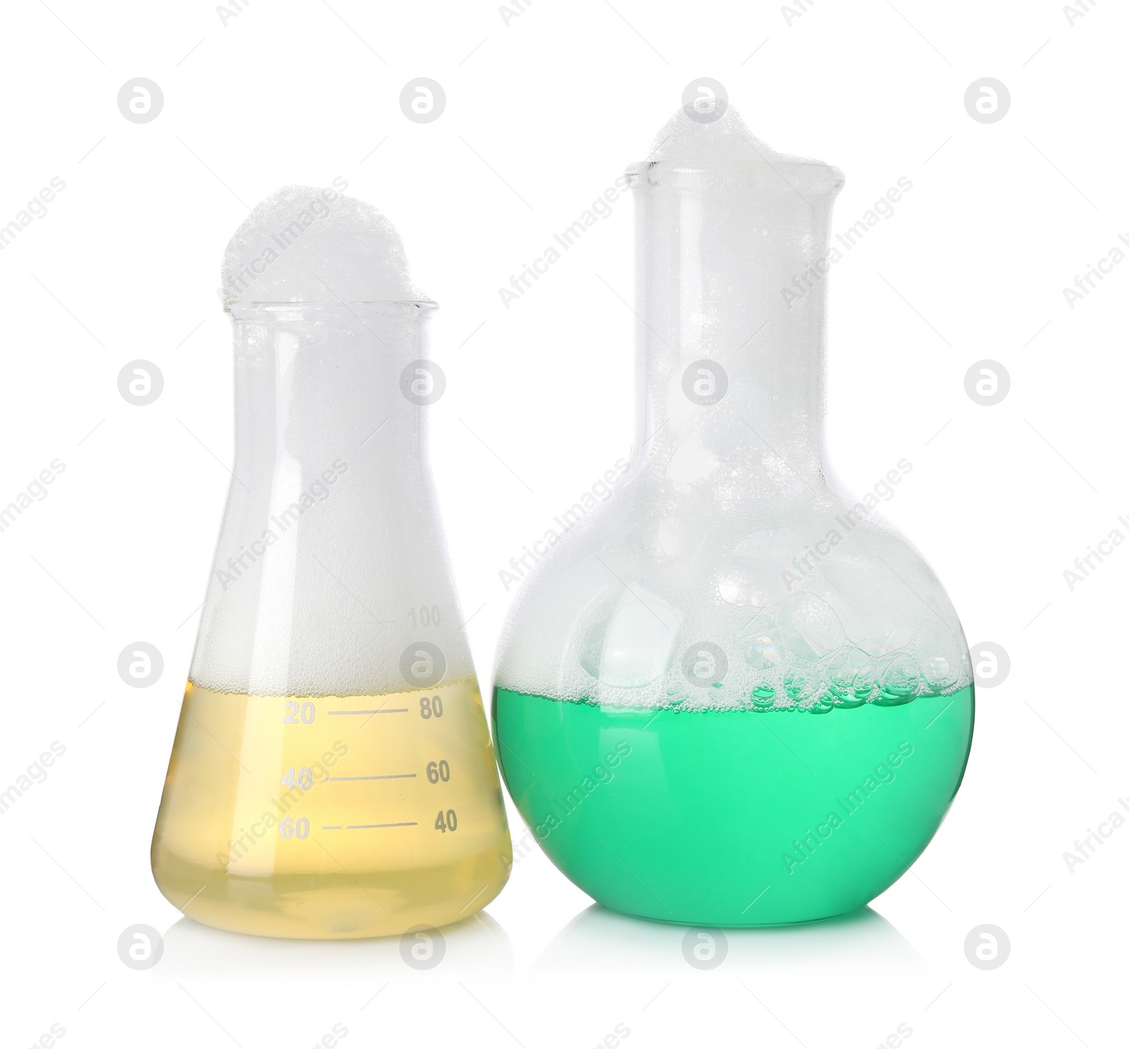 Photo of Laboratory flasks with colorful liquids isolated on white. Chemical reaction
