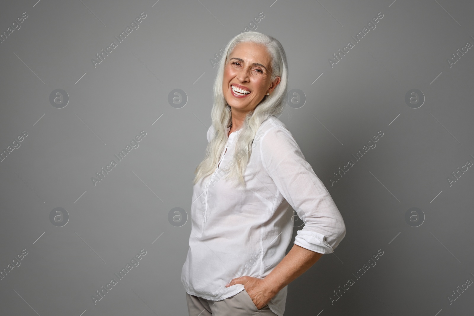 Photo of Portrait of beautiful mature woman on grey background