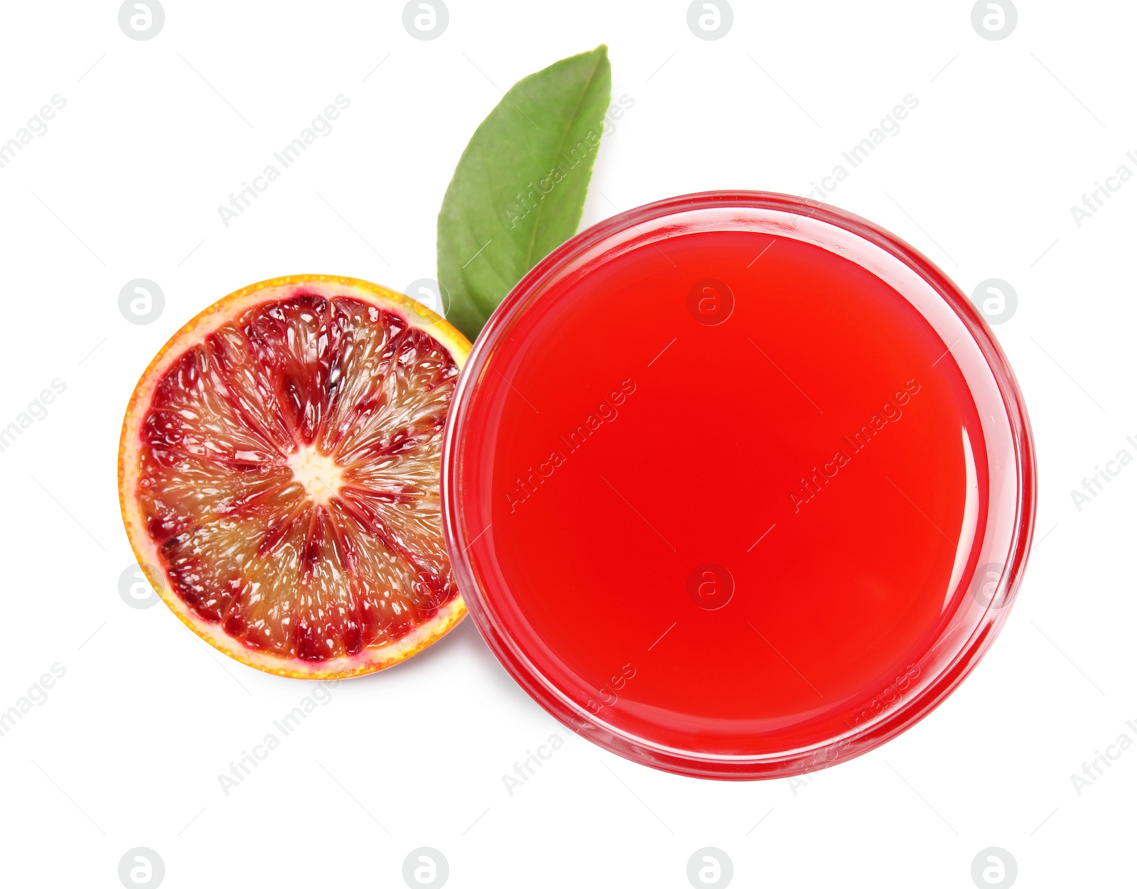 Photo of Tasty sicilian orange juice in glass, fruit and leaf on white background, top view