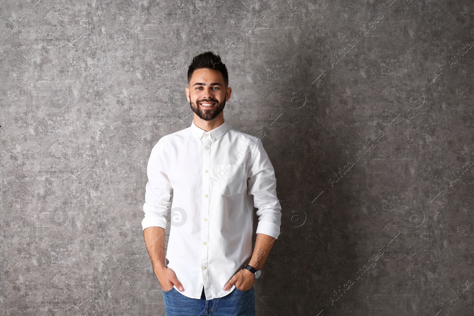 Photo of Portrait of handsome smiling man on grey background. Space for text