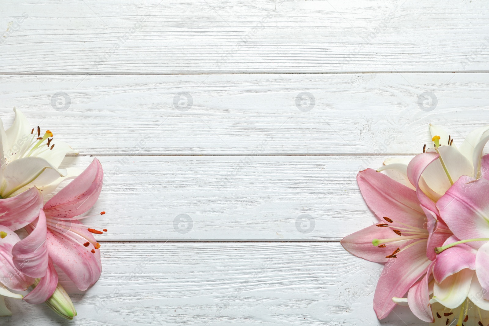 Photo of Flat lay composition with beautiful blooming lily flowers on wooden background