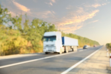 Blurred view of asphalt highway with truck. Road trip