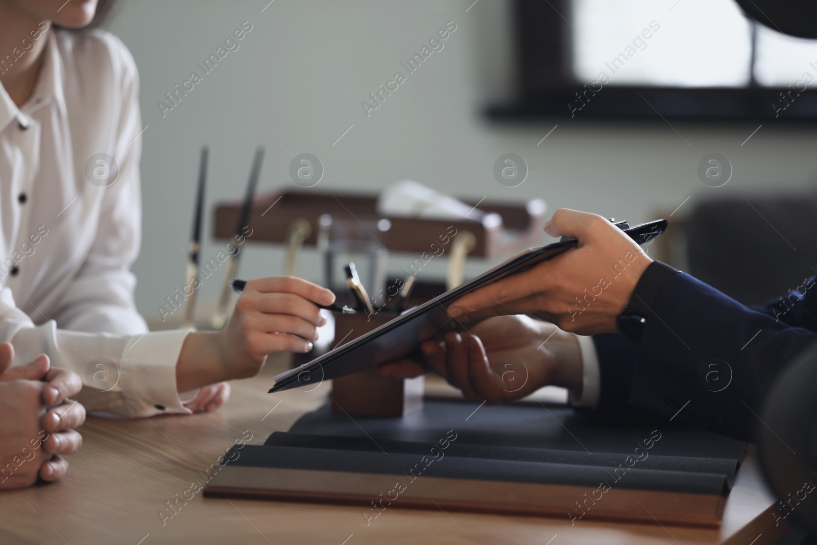 Photo of Male lawyer working with clients in office, closeup