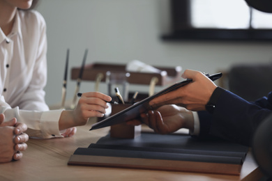 Male lawyer working with clients in office, closeup