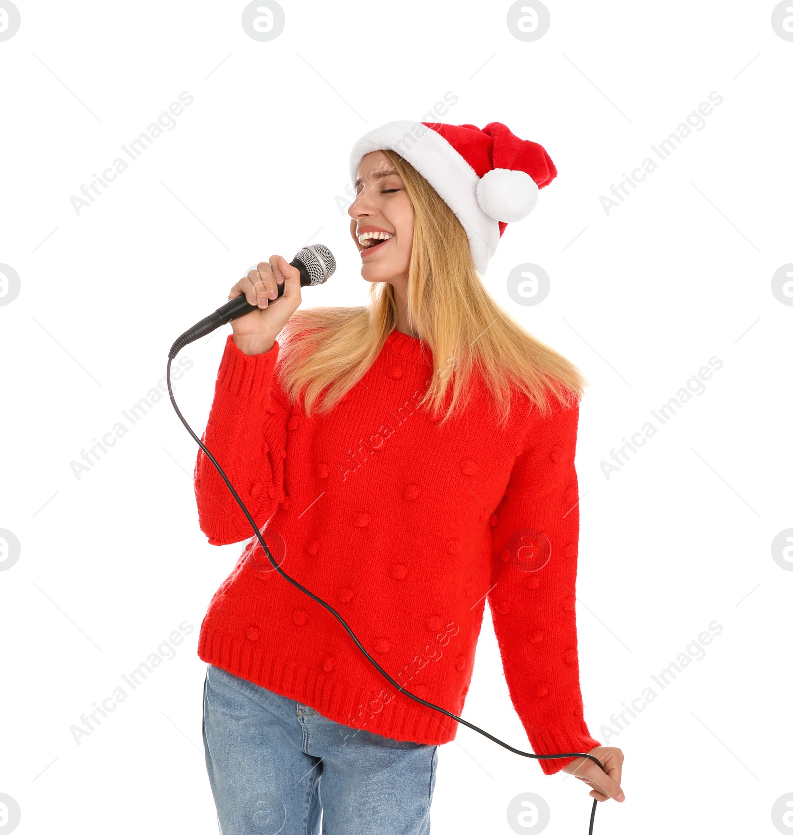 Photo of Happy woman in Santa Claus hat singing with microphone on white background. Christmas music