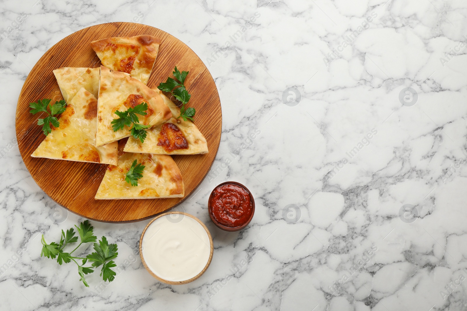 Photo of Delicious khachapuri with cheese served on white marble table, flat lay. Space for text