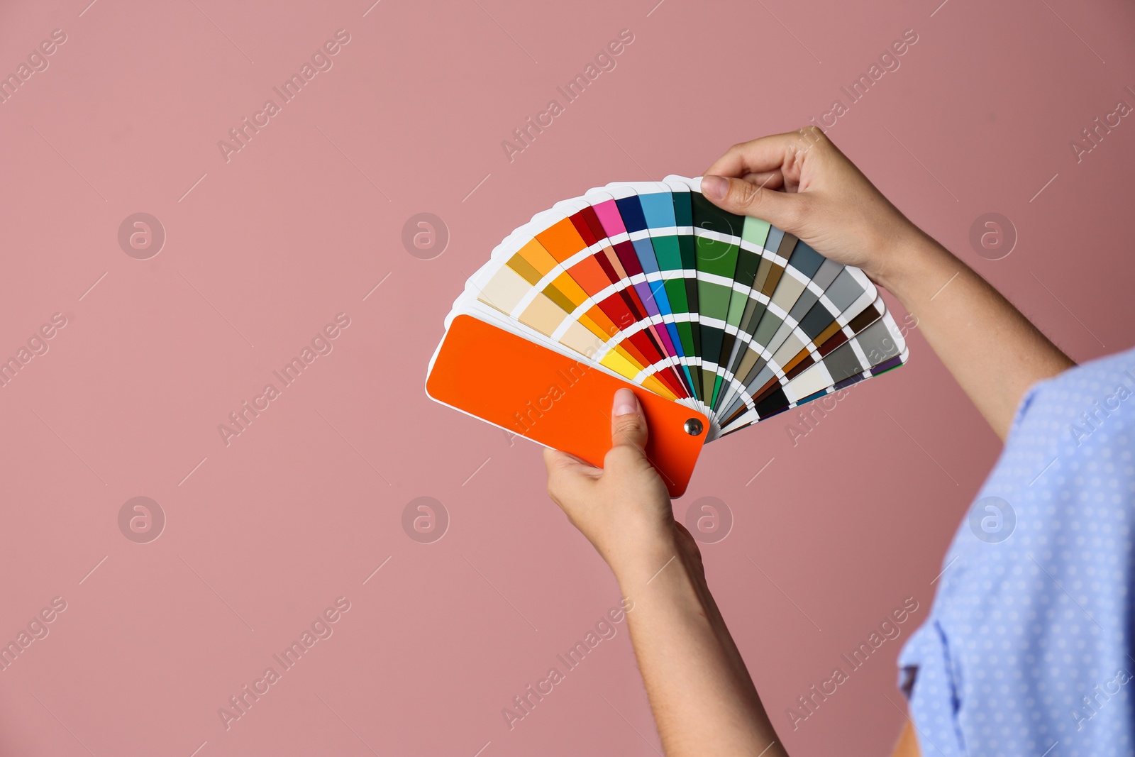 Photo of Female interior designer with palette samples on color background, closeup. Space for text