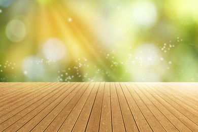 Image of Empty wooden surface against blurred green background. Bokeh effect