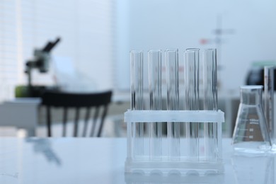 Photo of Laboratory analysis. Glass test tubes on white table indoors