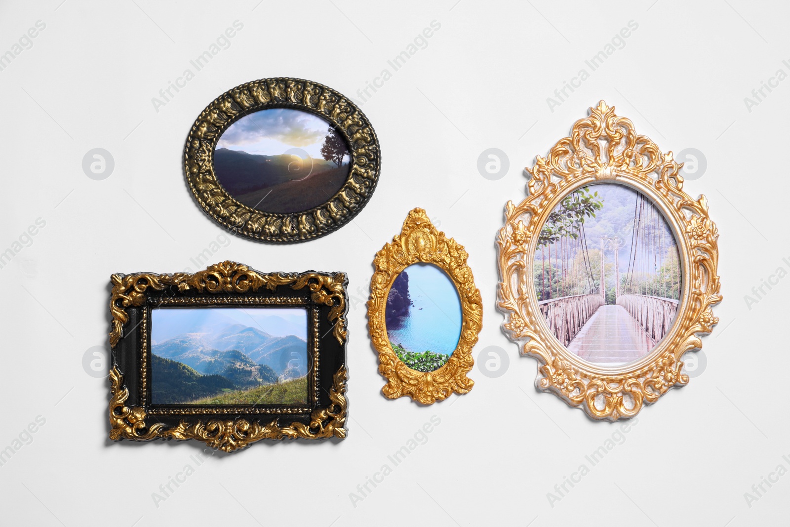 Photo of Vintage frames with photos of beautiful landscapes hanging on white wall