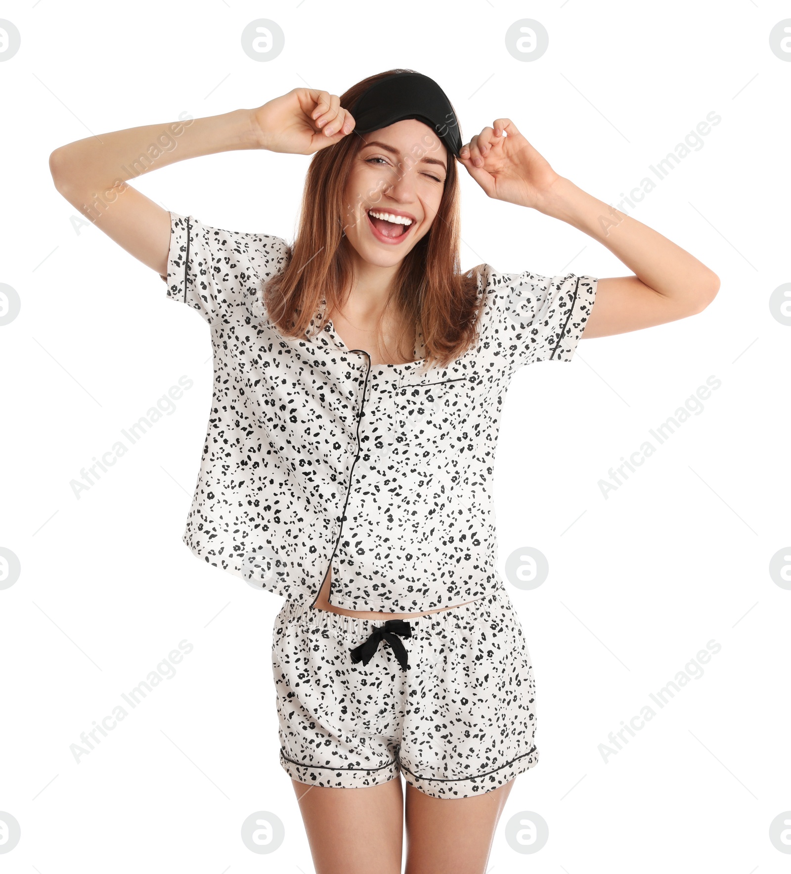 Photo of Beautiful woman wearing pajamas and sleep mask on white background. Bedtime