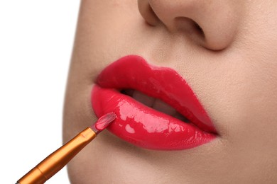 Photo of Woman applying lip gloss on white background, closeup