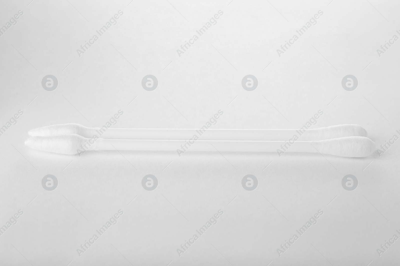 Photo of Clean cotton buds isolated on white. Hygienic product