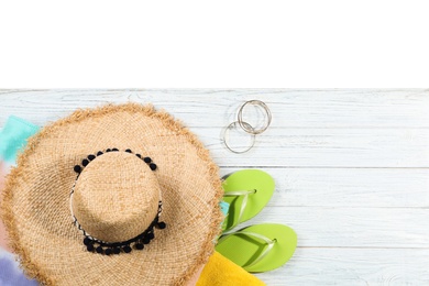 Photo of Flat lay composition with beach accessories on wooden background. Space for text