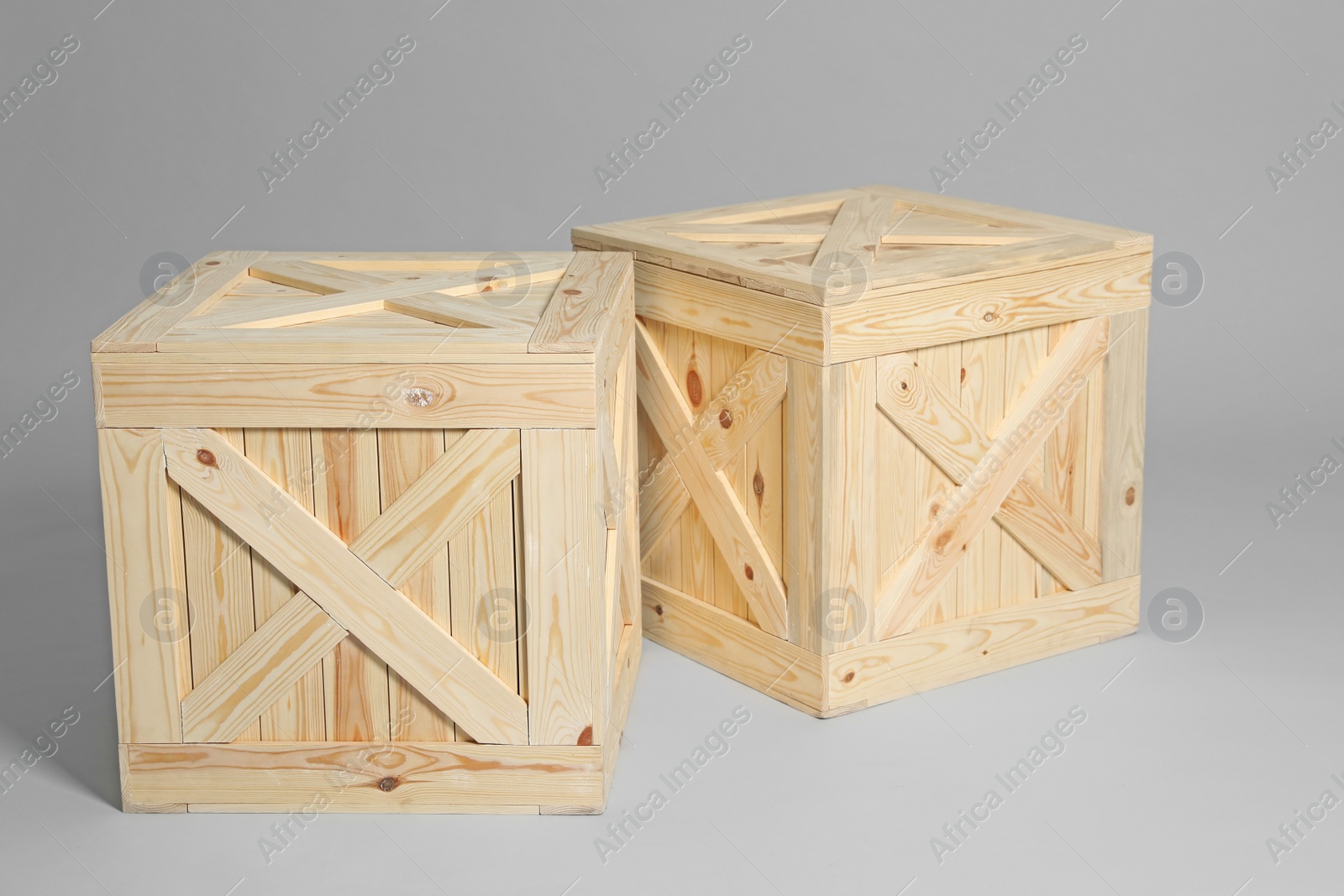 Photo of Pair of wooden crates on grey background