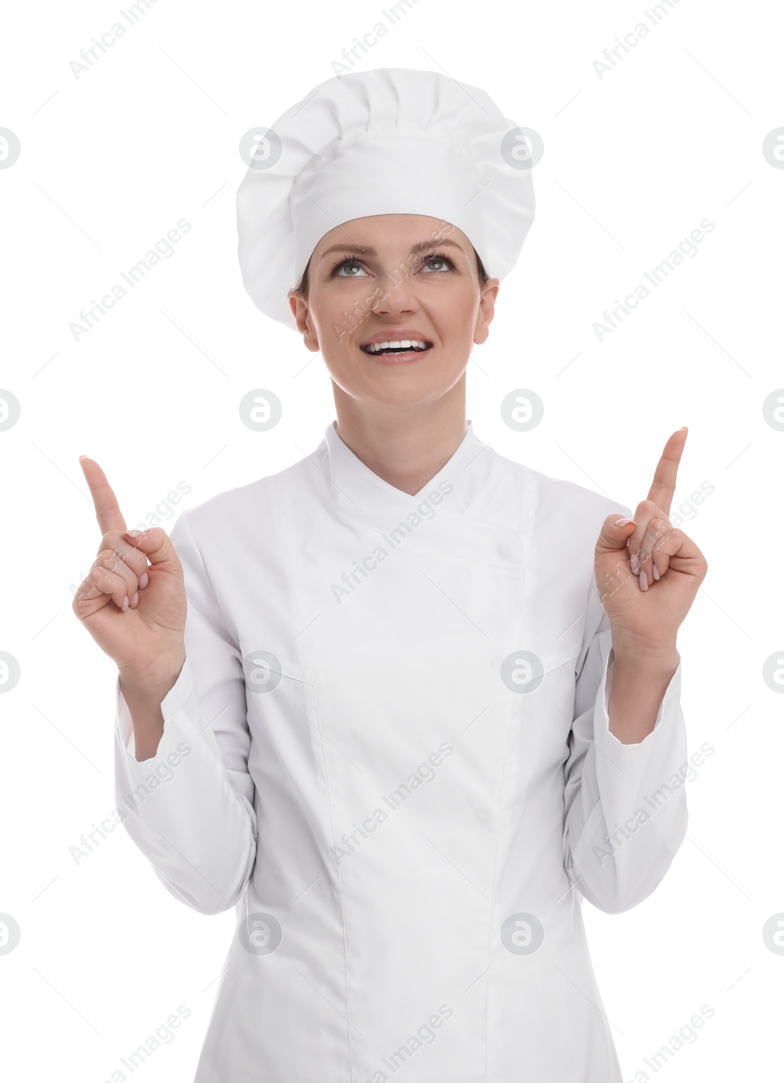 Photo of Happy woman chef in uniform pointing at something on white background