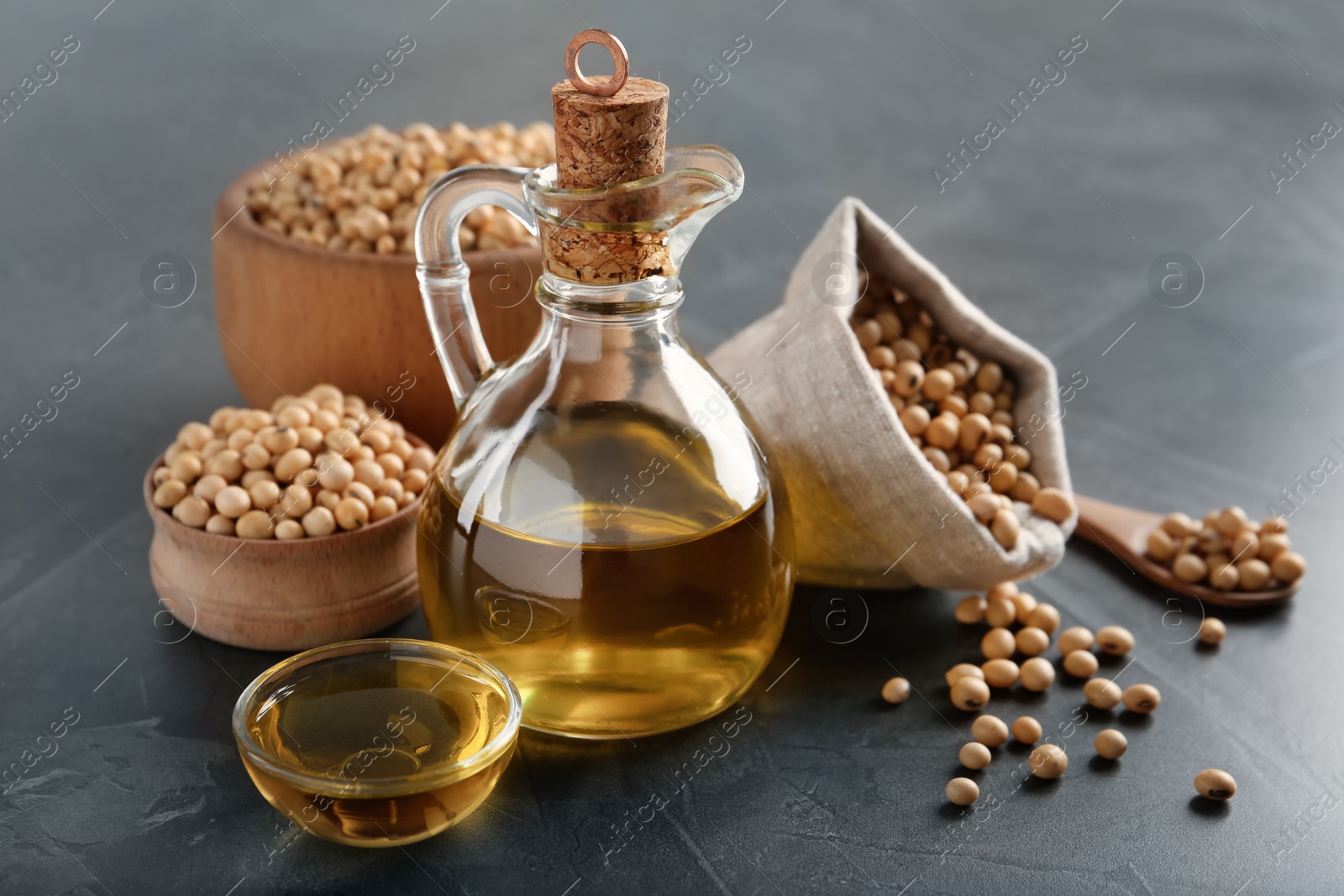 Photo of Composition with soybean oil on grey table