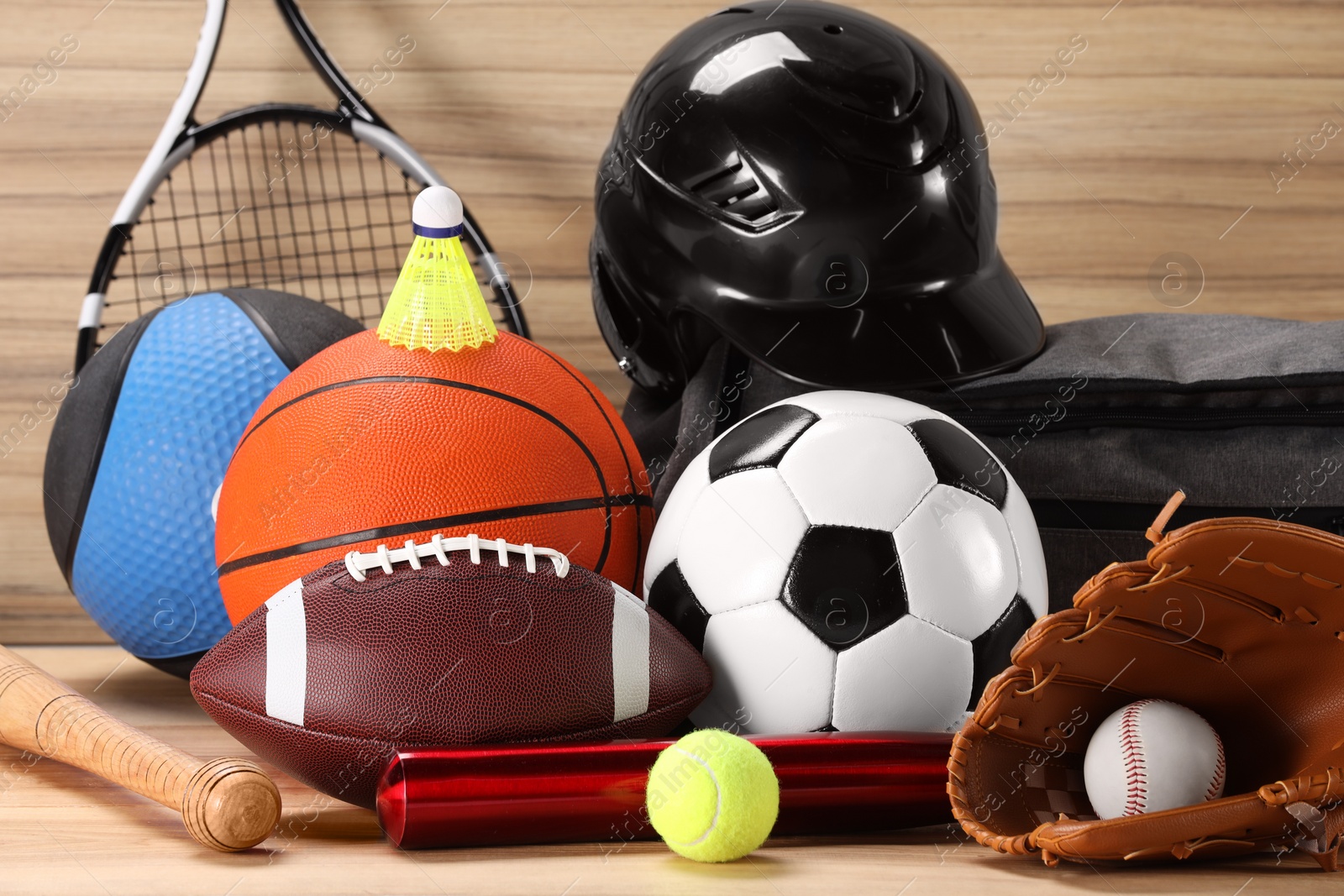 Photo of Many different sports equipment on wooden table