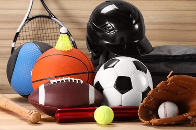 Photo of Many different sports equipment on wooden table