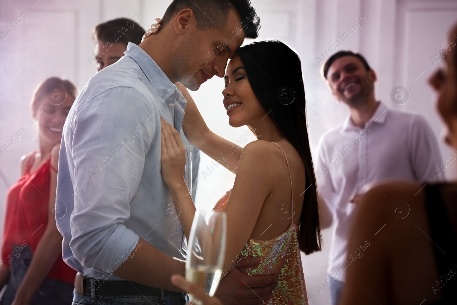 Photo of Lovely young couple dancing together at party