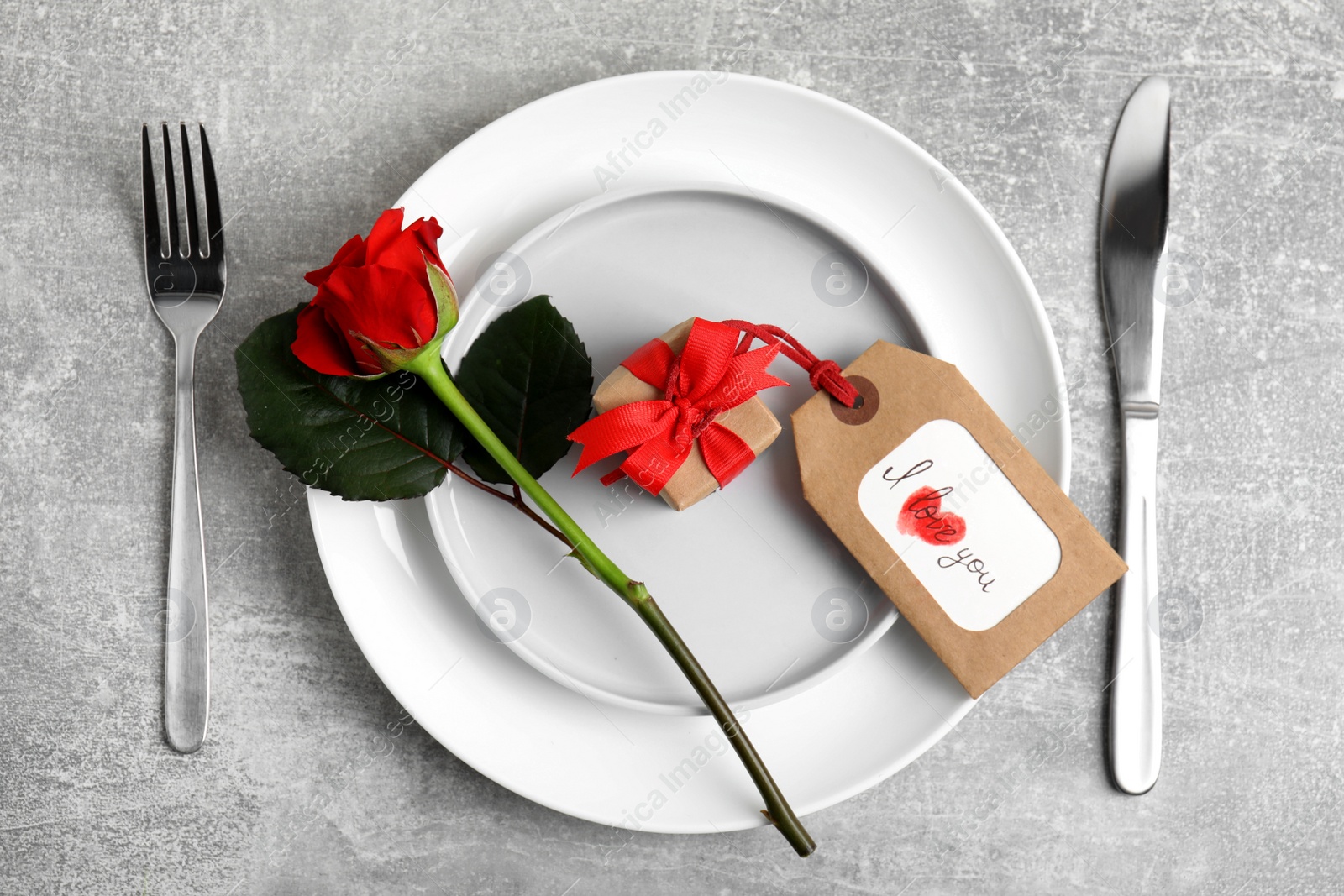 Photo of Beautiful table setting for romantic dinner on light grey background, flat lay. Valentine's day celebration