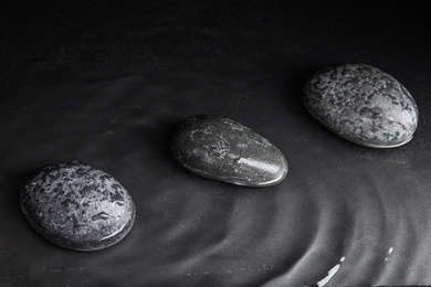 Stones in water on grey background. Zen lifestyle