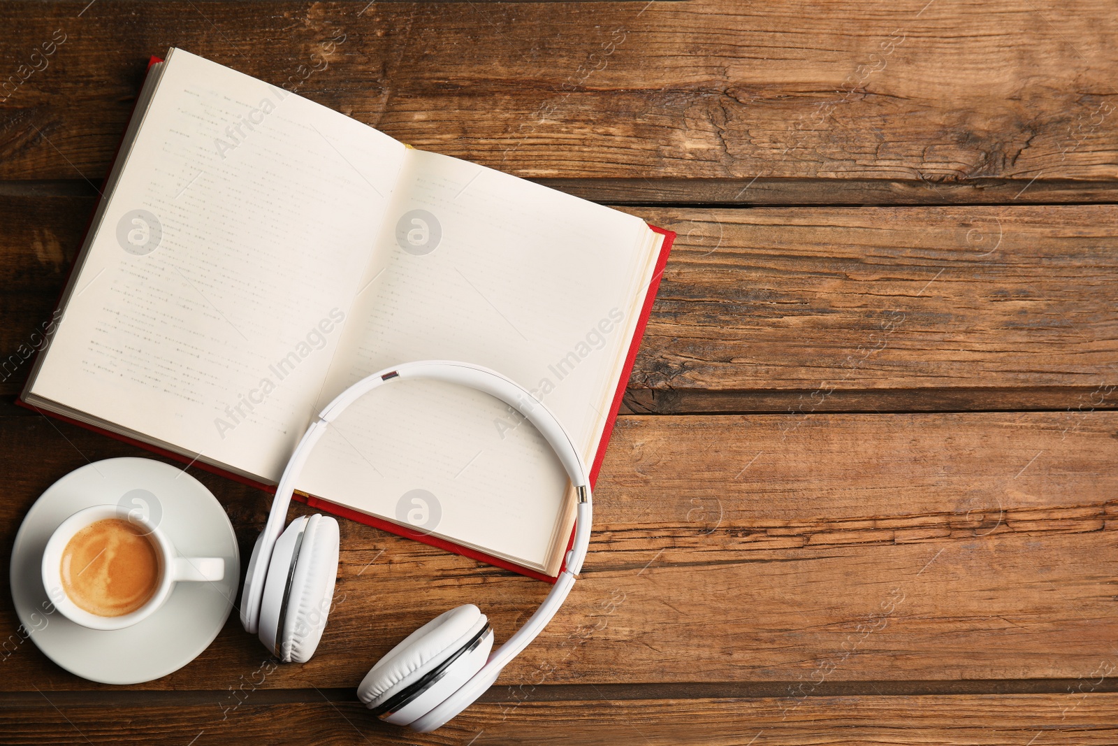 Photo of Book, coffee and headphones on wooden table, flat lay. Space for text