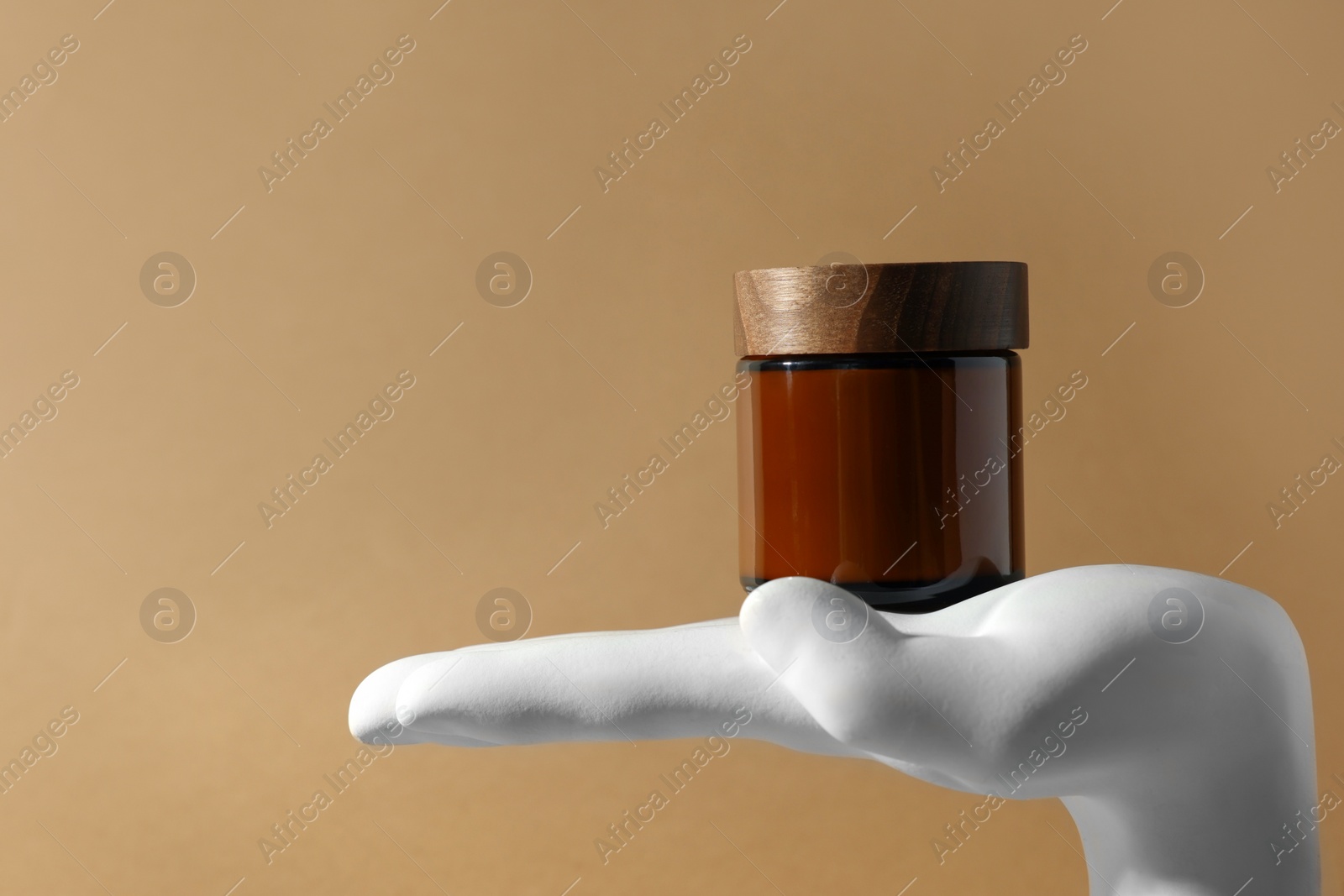 Photo of Composition with jar of luxury cream on dark beige background, space for text