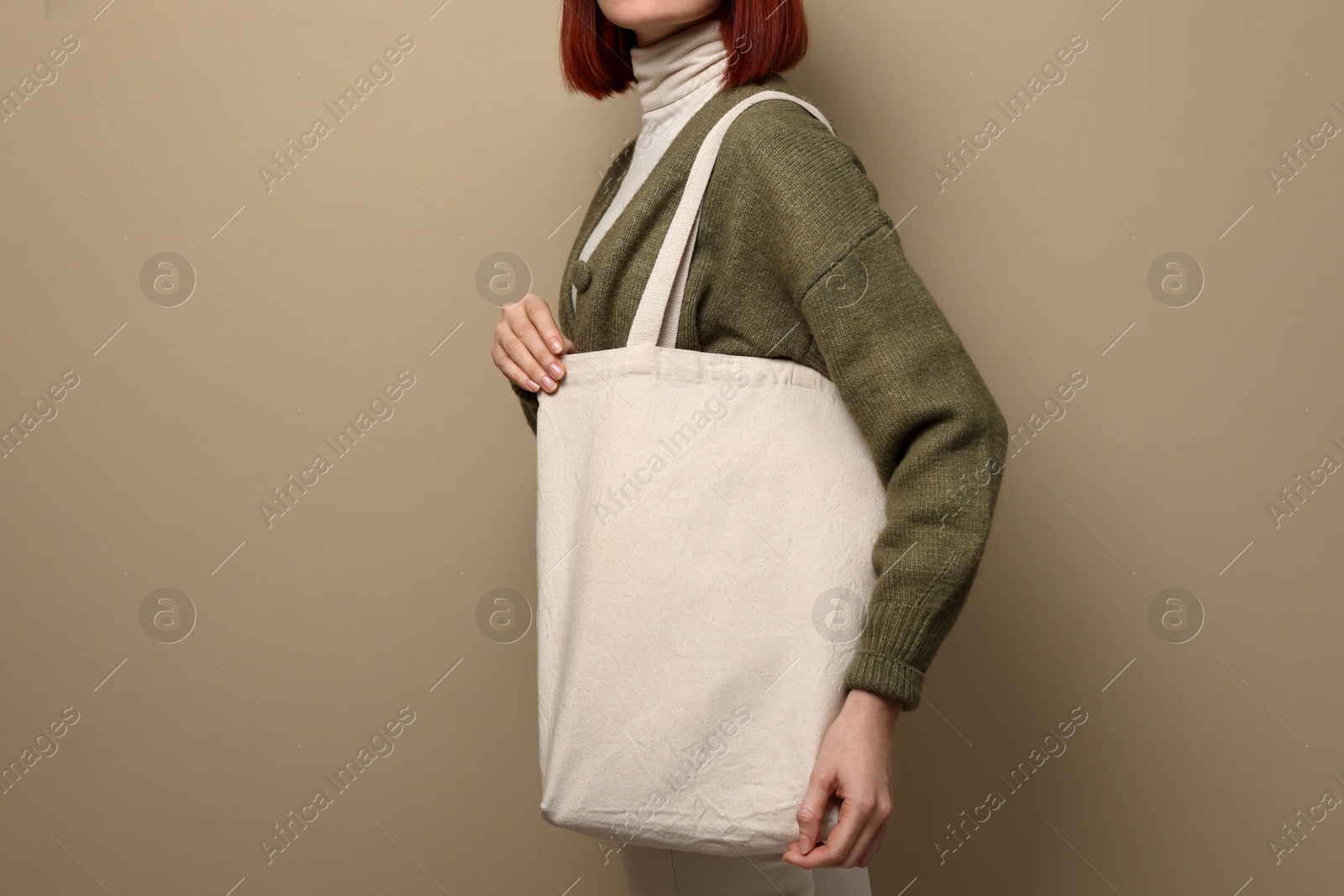 Photo of Woman with eco bag on beige background, closeup. Space for text