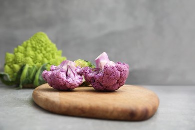 Photo of Fresh purple cauliflower on grey table, closeup