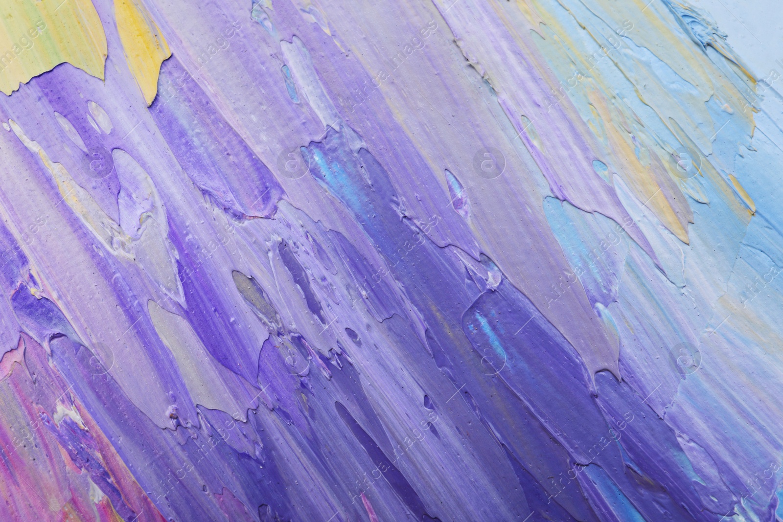 Photo of Beautiful strokes of colorful oil paints as background, closeup