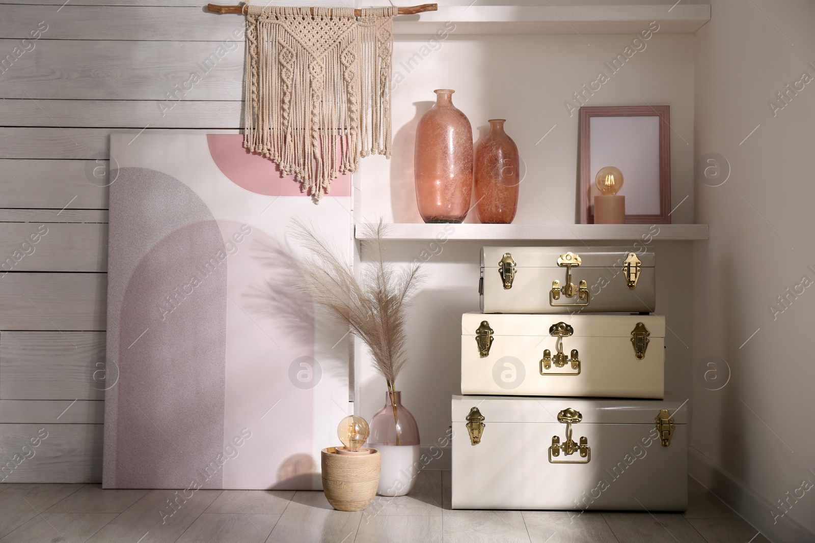 Photo of Stylish storage trunks and different decor elements near white wall indoors. Interior design