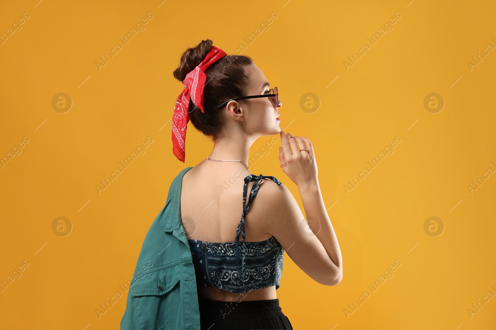 Photo of Woman with stylish bandana on yellow background