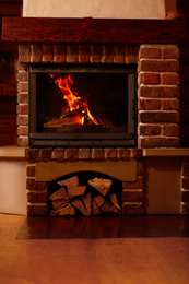 Photo of Fireplace with burning wood indoors. Winter vacation