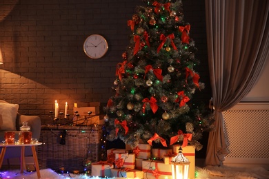 Photo of Stylish room interior with decorated Christmas tree