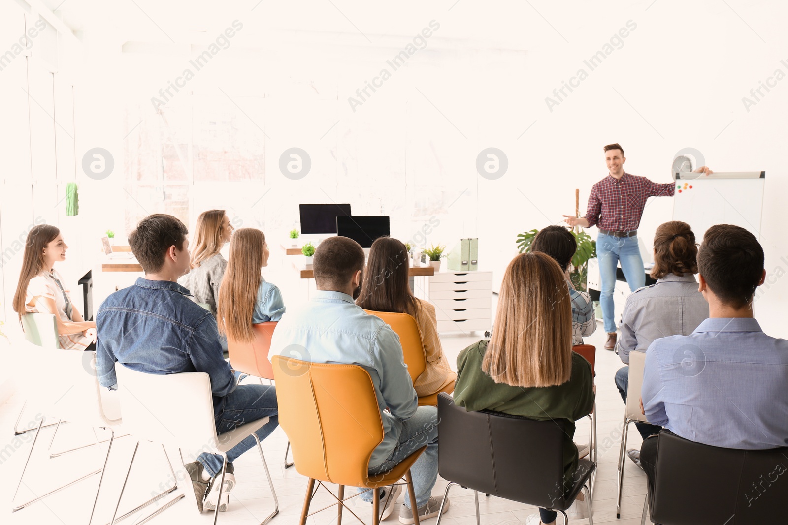 Photo of Male business trainer giving lecture in office