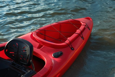 Photo of Beautiful modern red kayak on river, closeup