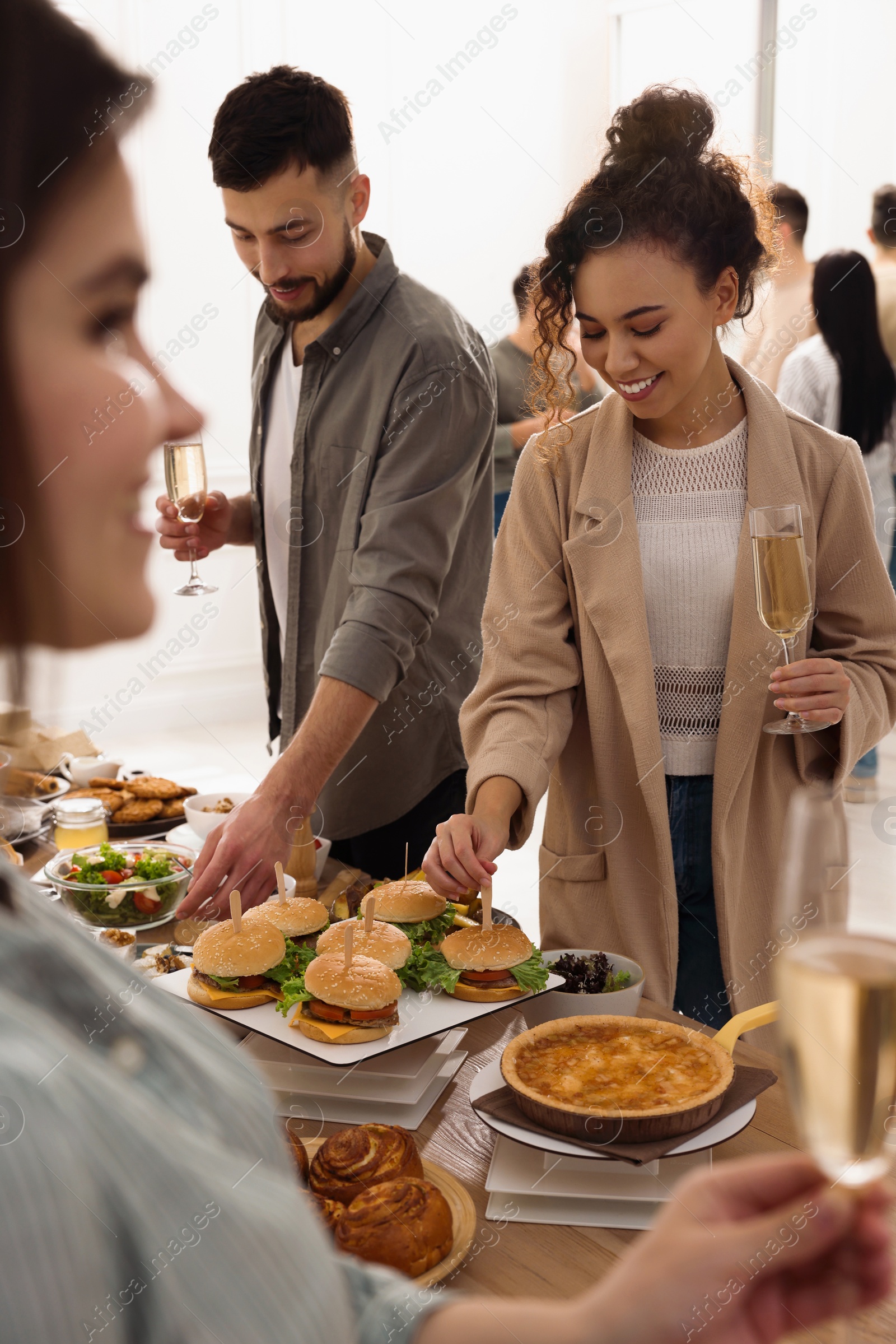 Photo of Group of people enjoying brunch buffet together indoors