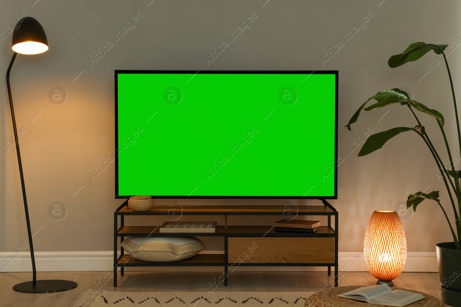 Image of Modern TV set on stand in room