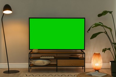 Image of Modern TV set on stand in room