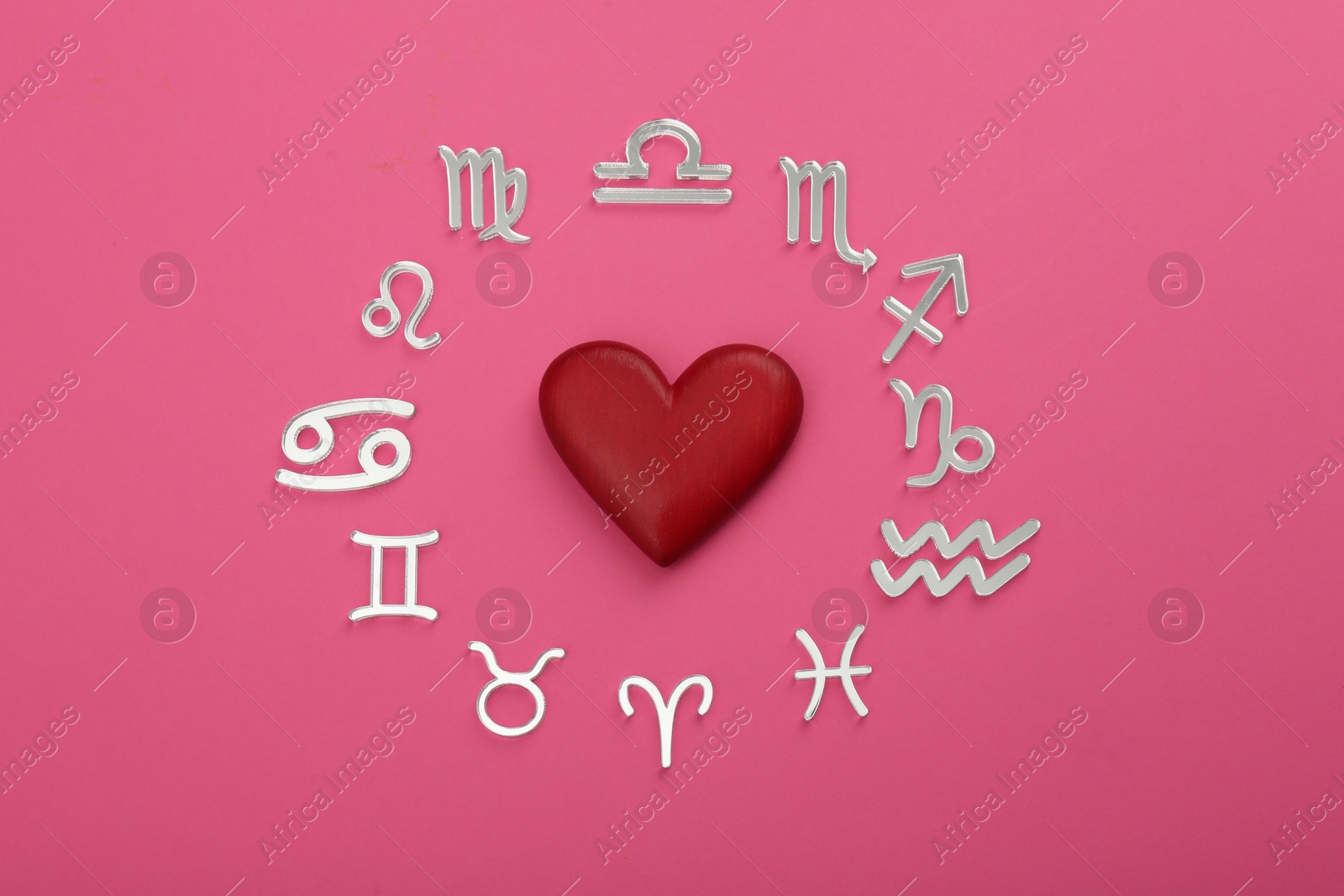 Photo of Zodiac signs and red heart on pink background, flat lay