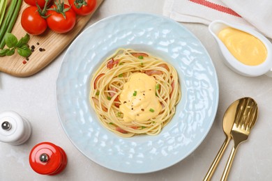 Photo of Delicious spaghetti with meat and cheese sauce served on light grey table, flat lay