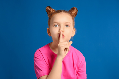 Photo of Portrait of emotional girl on blue background