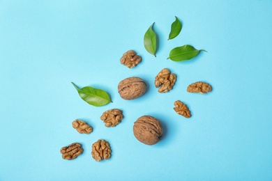 Photo of Flat lay composition with tasty walnuts on color background