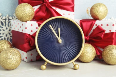 Photo of Alarm clock, gifts and decorations on table. Christmas countdown