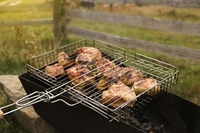 Photo of Cooking tasty meat on barbecue grill outdoors